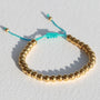 Armband gouden kraal lila