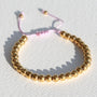 Armband gouden kraal lila